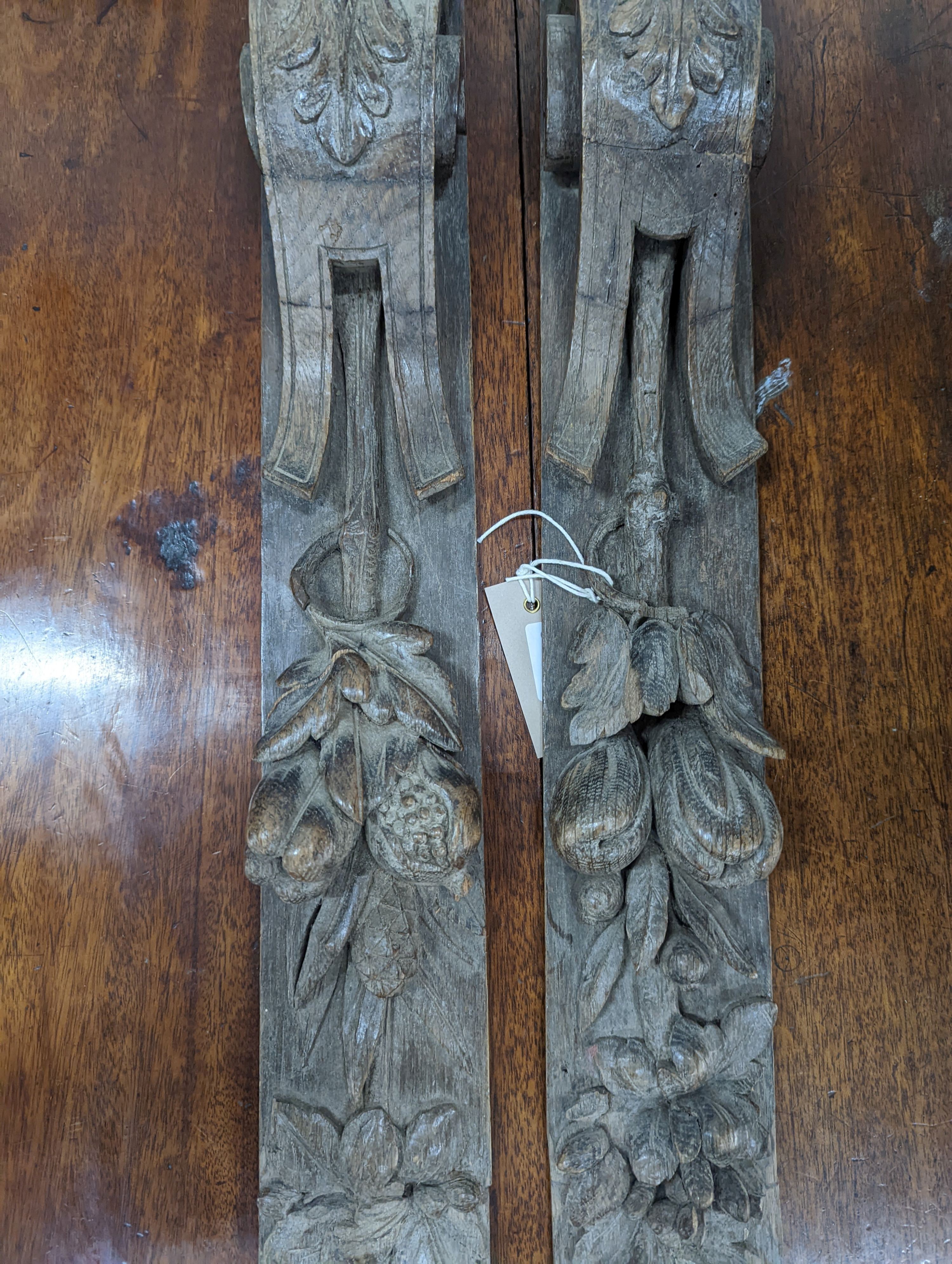 A pair of 19th century carved oak appliques, height 80cm